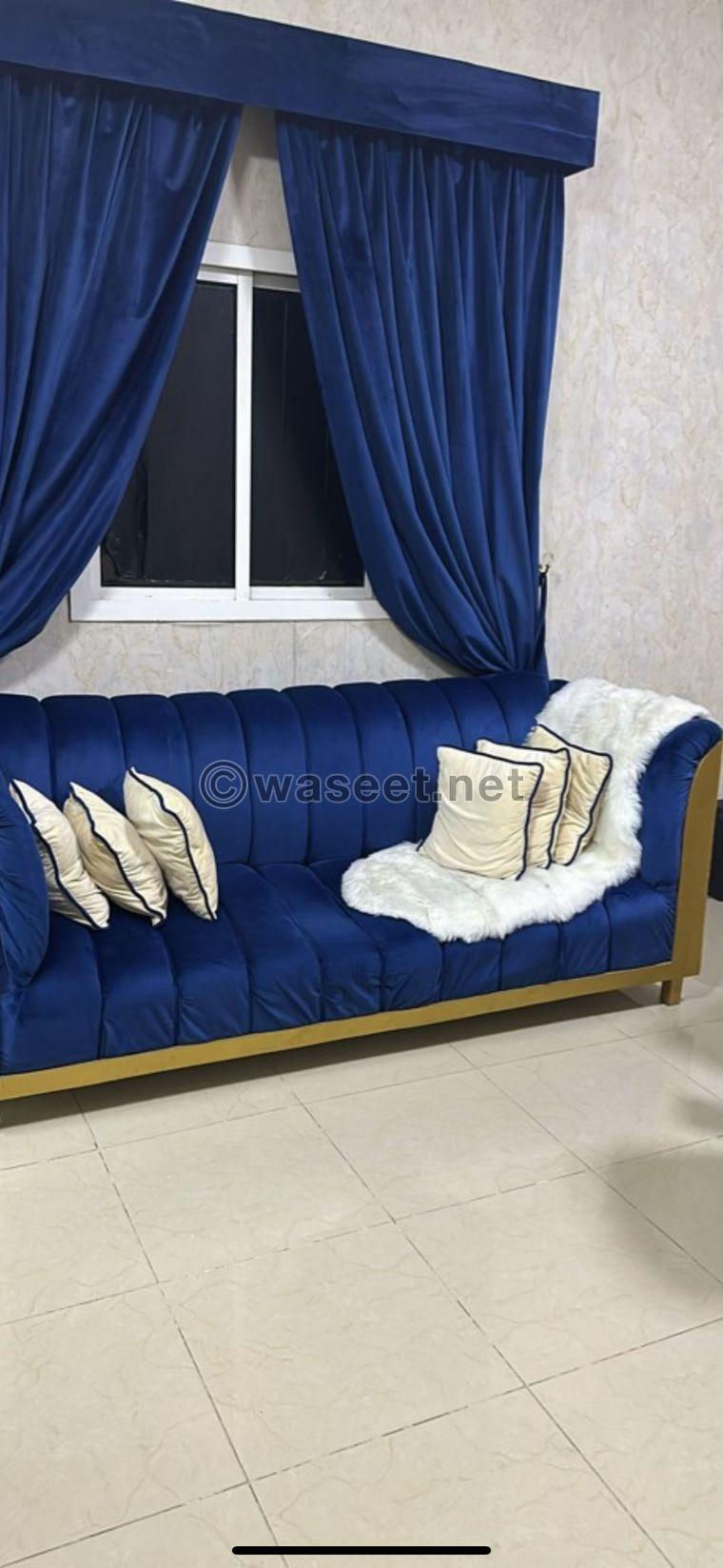 A seating set with a curtain and 2 tables  0
